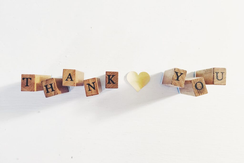 Wooden blocks with black letters that spell out thank you