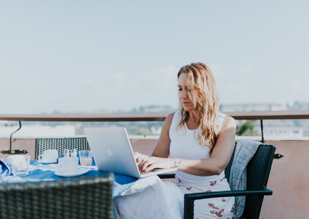 A woman working on a macbook