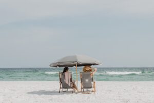 women sitting on the beach