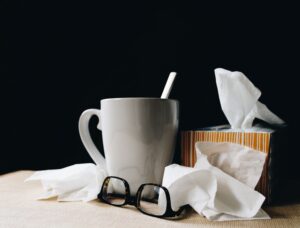 A mug, tissue box, and reading glasses