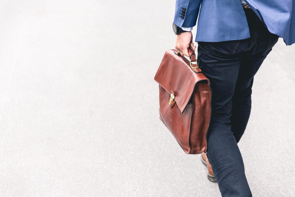 A man walking and carrying a briefcase