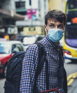 A male wearing a mask in city