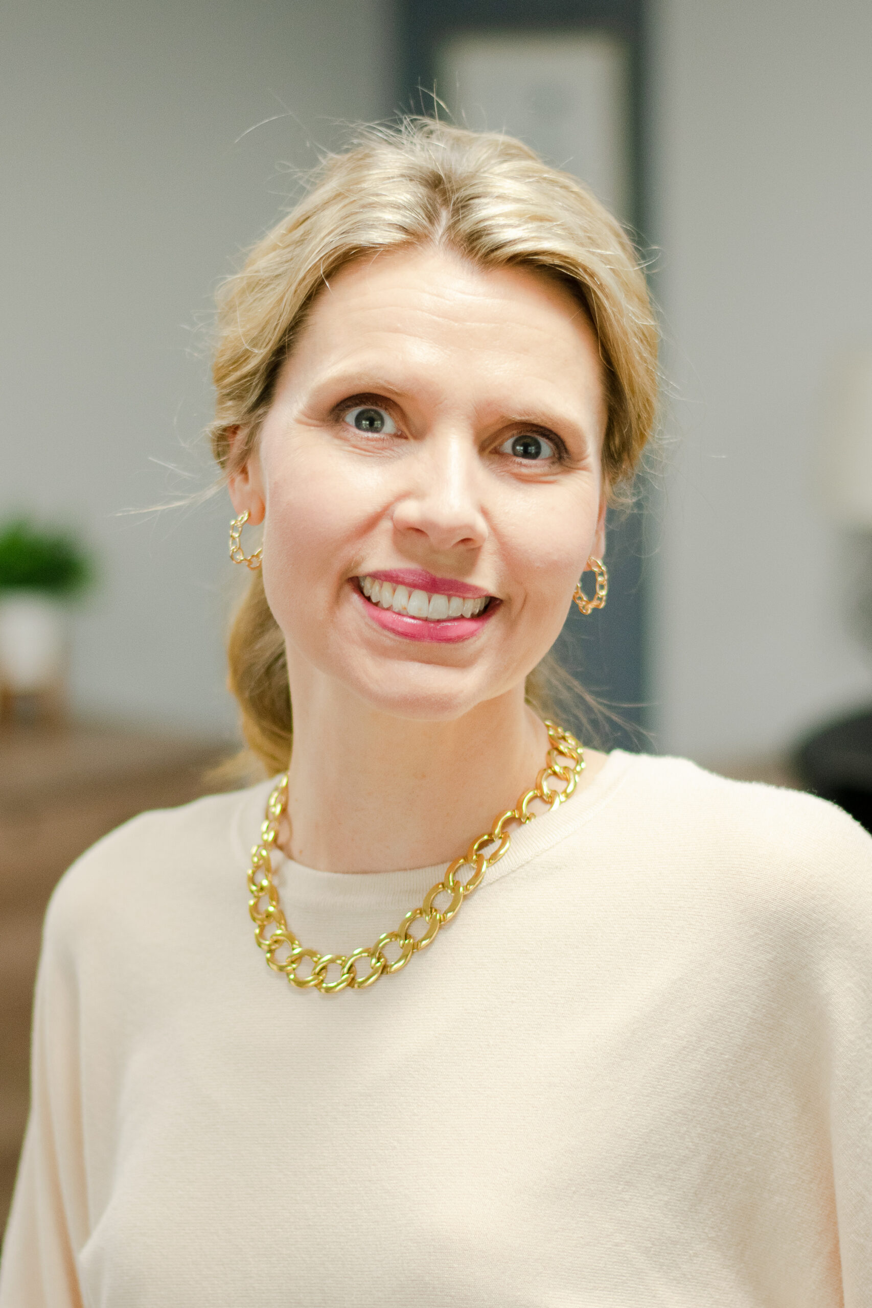 Headshot of a smiling female worker in professional attire.