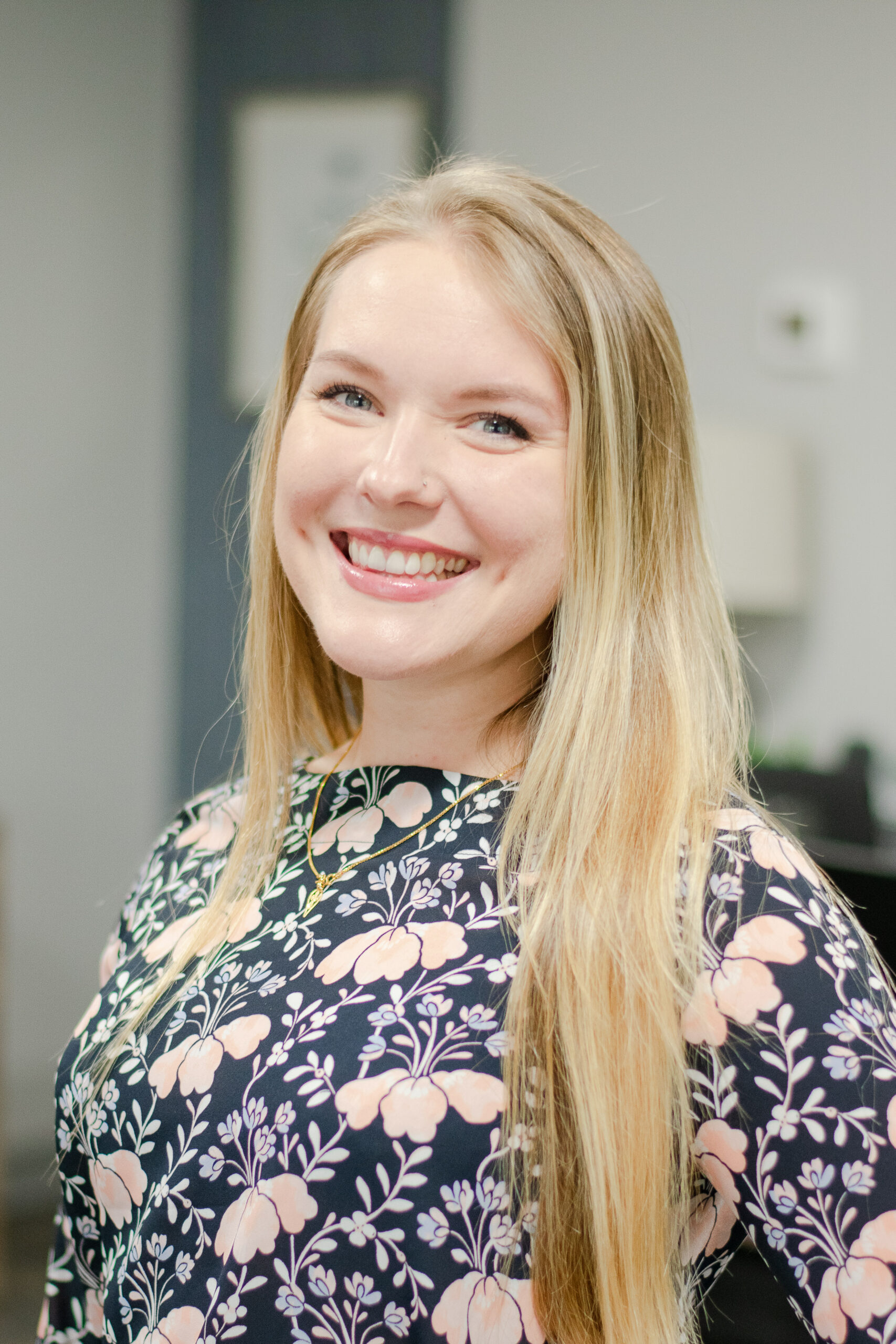 Headshot of a smiling female worker in professional attire.