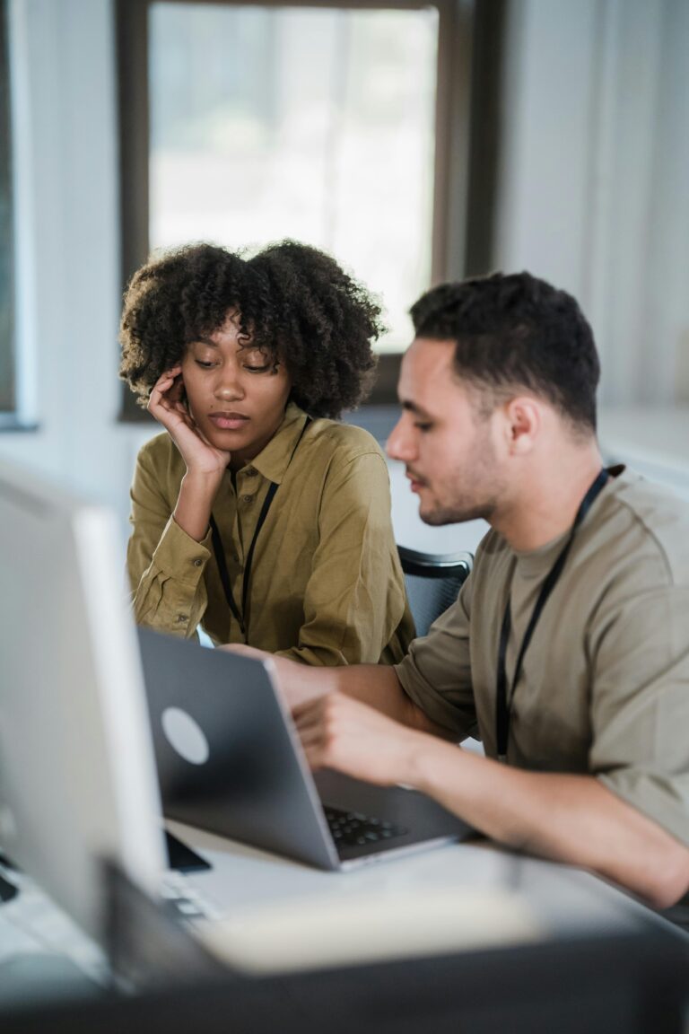 Co-workers working together in front of a computer