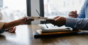 A worker handing documents to client